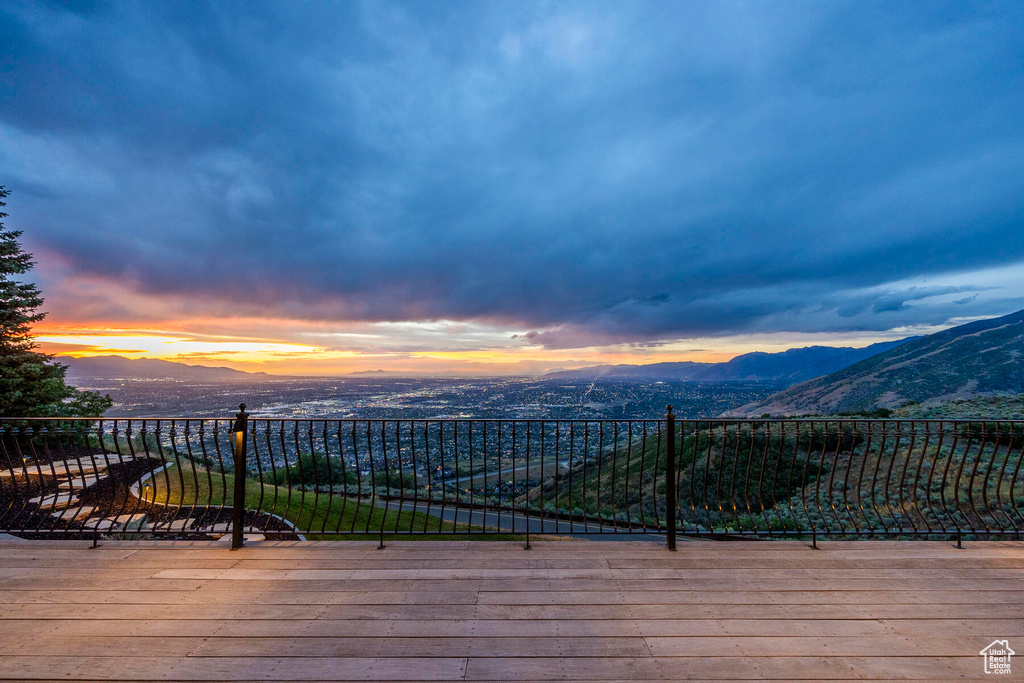 Deck at dusk featuring a mountain view