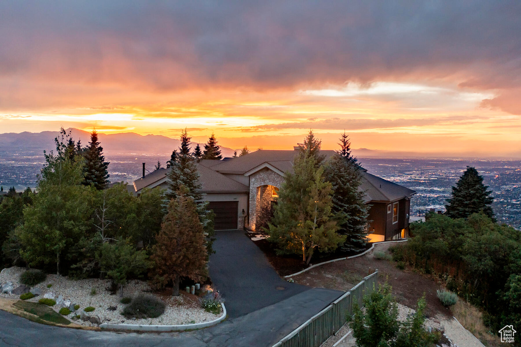 Obstructed view of property with a mountain view and a garage