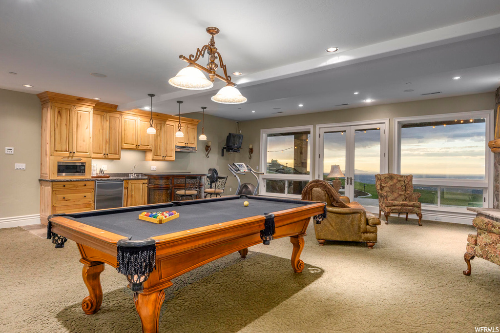 Recreation room featuring french doors, light colored carpet, wet bar, and pool table