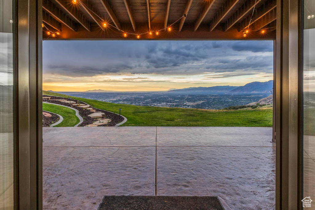 Doorway to outside with a mountain view and beam ceiling