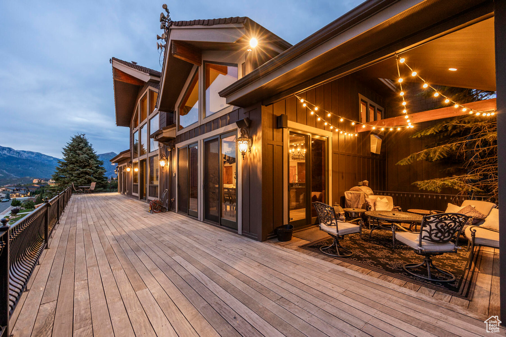 Deck at dusk featuring a mountain view