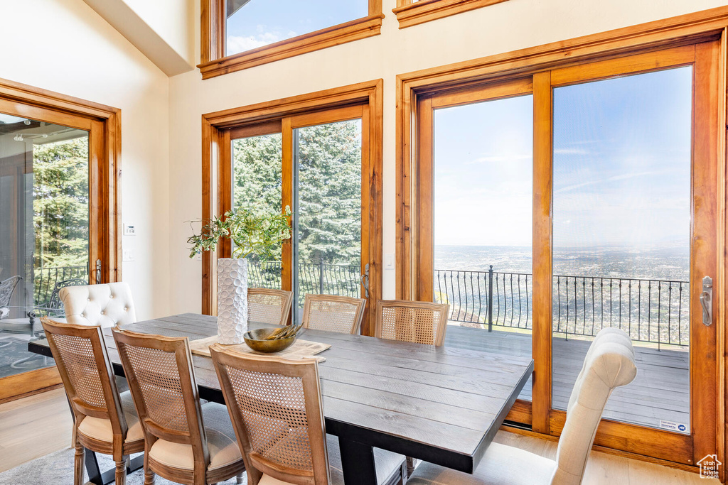 Sunroom / solarium with lofted ceiling, a water view, and plenty of natural light