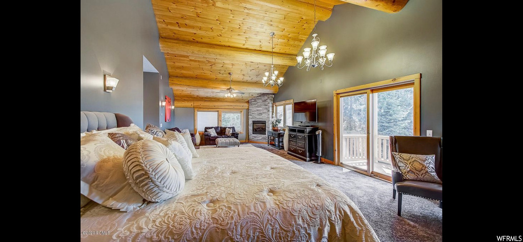 Bedroom featuring a stone fireplace, vaulted ceiling high, wooden ceiling, carpet floors, and an inviting chandelier