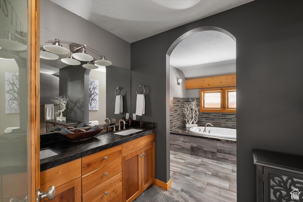 Bathroom with double vanity and a garden tub