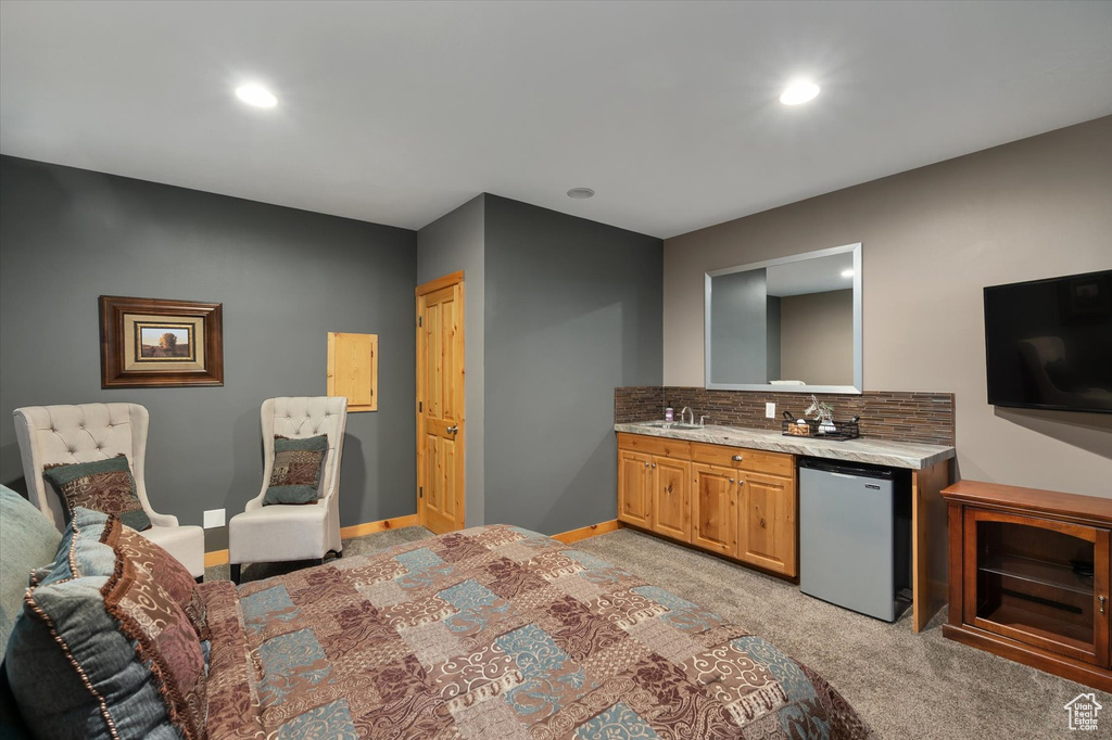 Kitchen featuring fridge, light carpet, a sink, tasteful backsplash, and recessed lighting