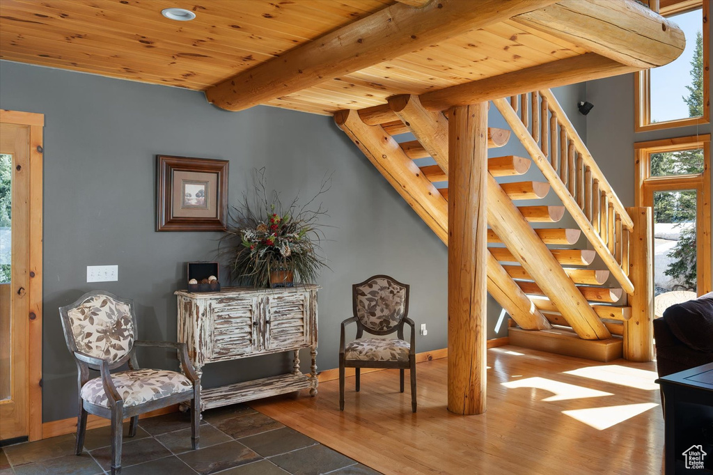 Sitting room with stairs, beam ceiling, wood ceiling, baseboards, and recessed lighting