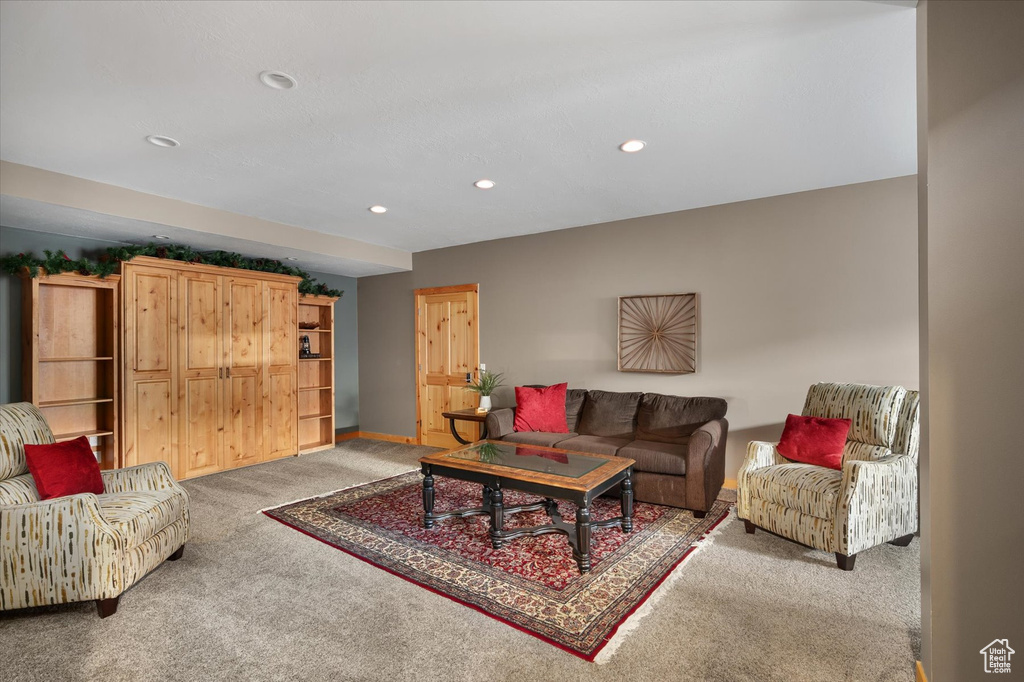 Living area featuring light carpet, recessed lighting, and baseboards