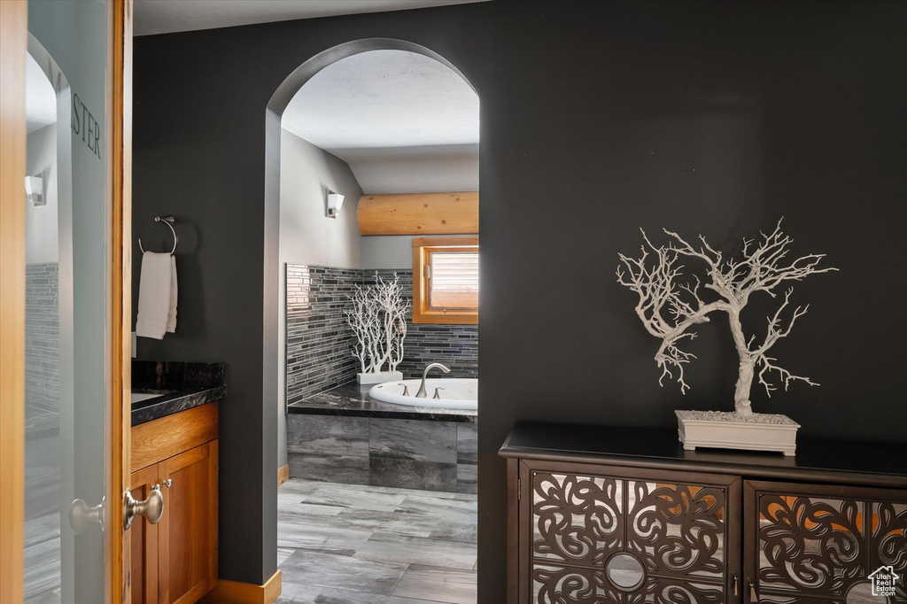 Full bathroom featuring vanity and a garden tub