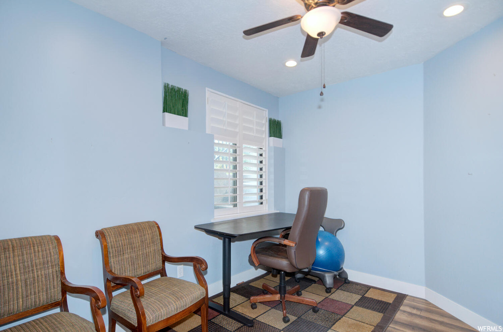 Hardwood floored office with ceiling fan