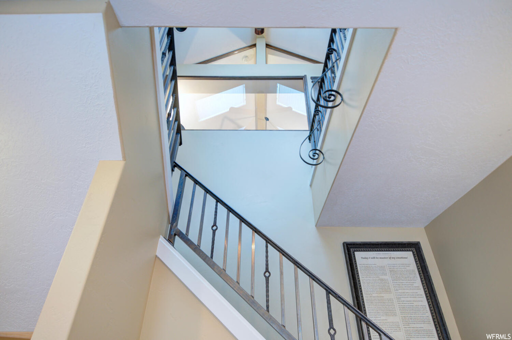 Stairs featuring a towering ceiling