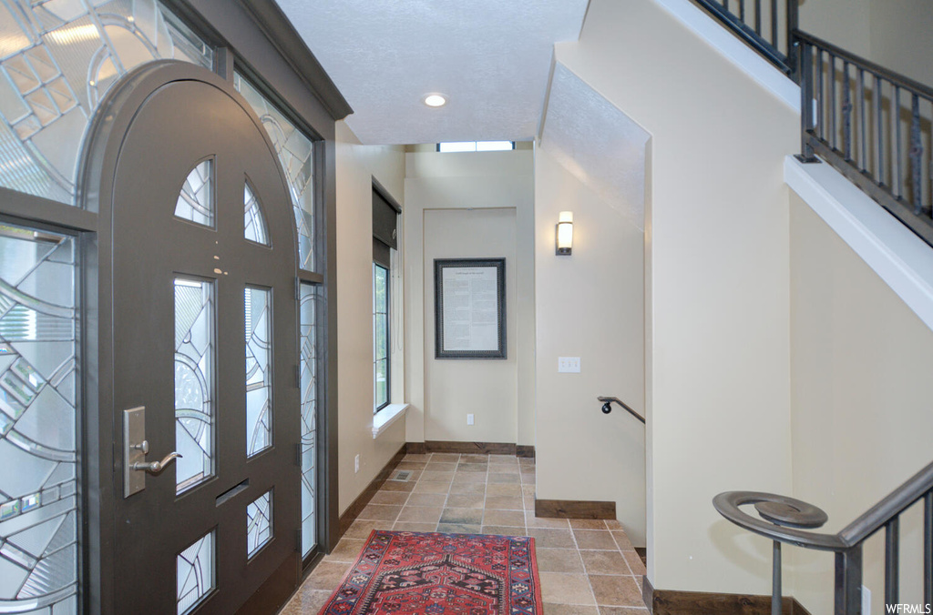 Entryway with light tile flooring