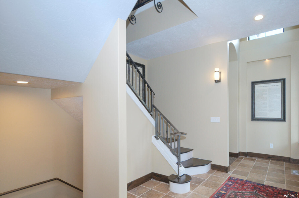 Stairway with light tile flooring