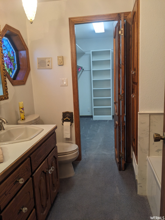 Full bathroom with oversized vanity, toilet, and  shower combination