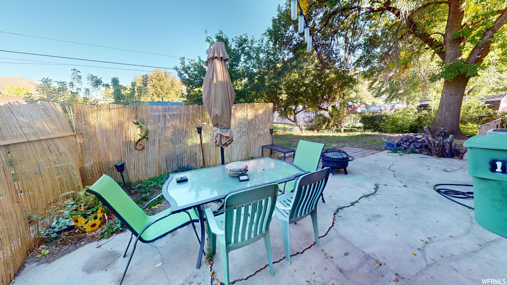 View of patio featuring an outdoor fire pit
