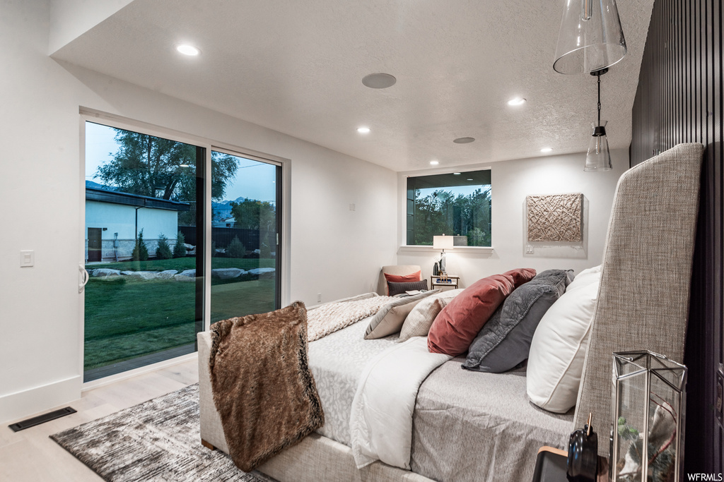 Bedroom featuring light hardwood floors and access to outside