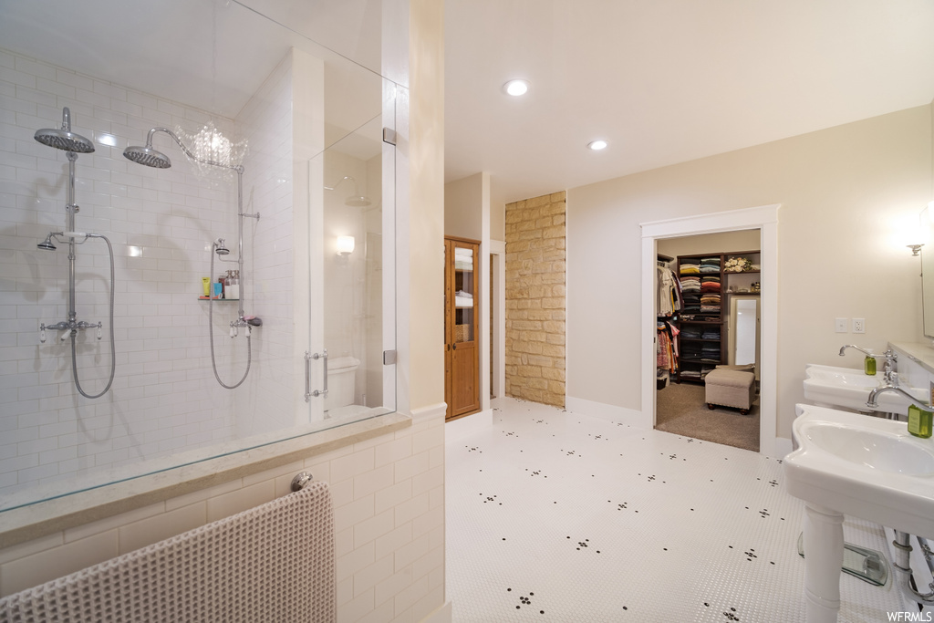 Bathroom featuring tile floors, a tile shower, and radiator