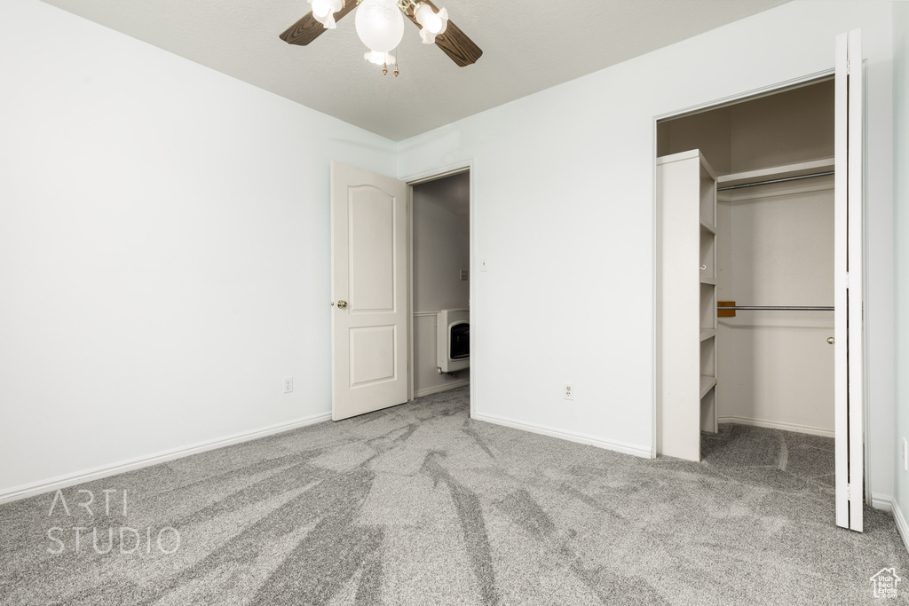 Unfurnished bedroom with light carpet, ceiling fan, and a closet