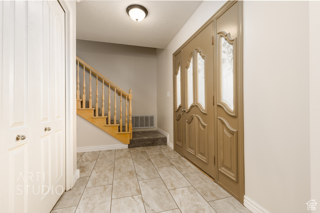 Foyer with light tile floors