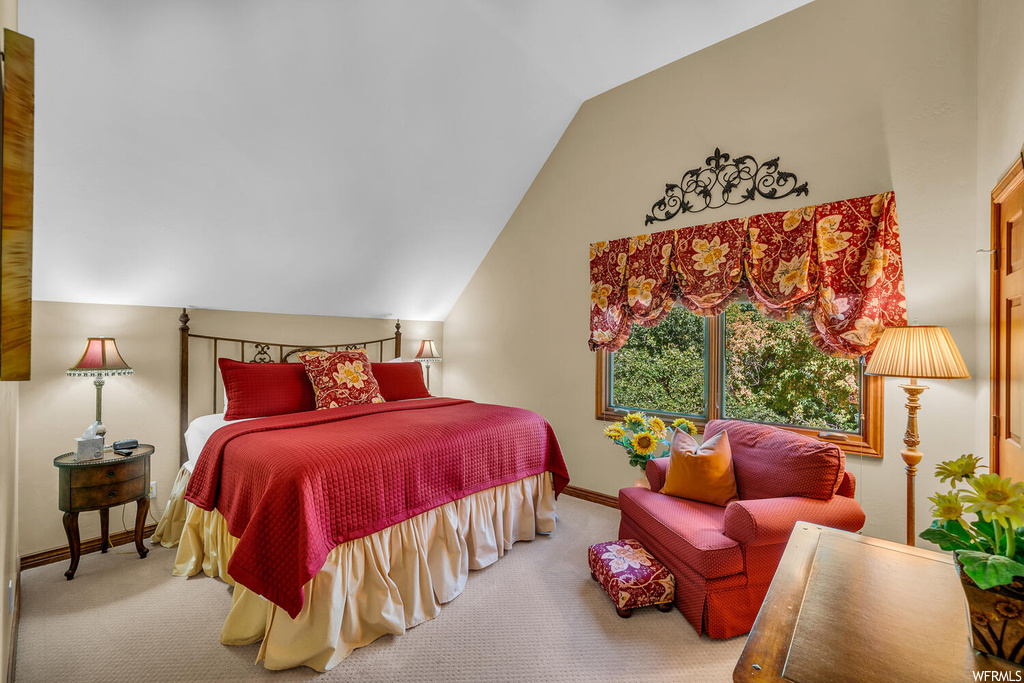 Bedroom with light carpet and vaulted ceiling