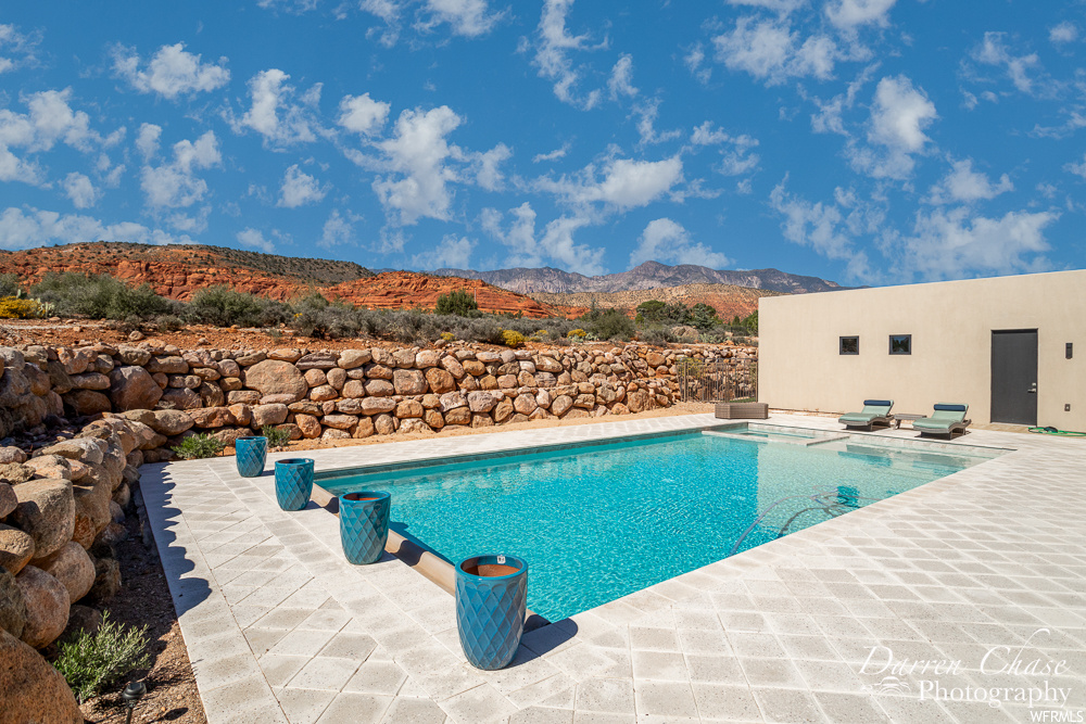 View of swimming pool featuring a patio and a mountain view