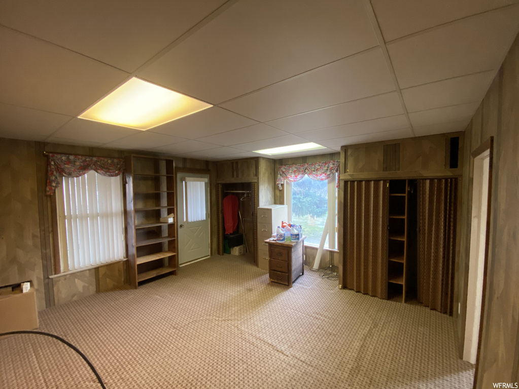 Miscellaneous room featuring light colored carpet and a drop ceiling