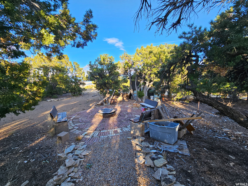 View of yard featuring a patio and a fire pit