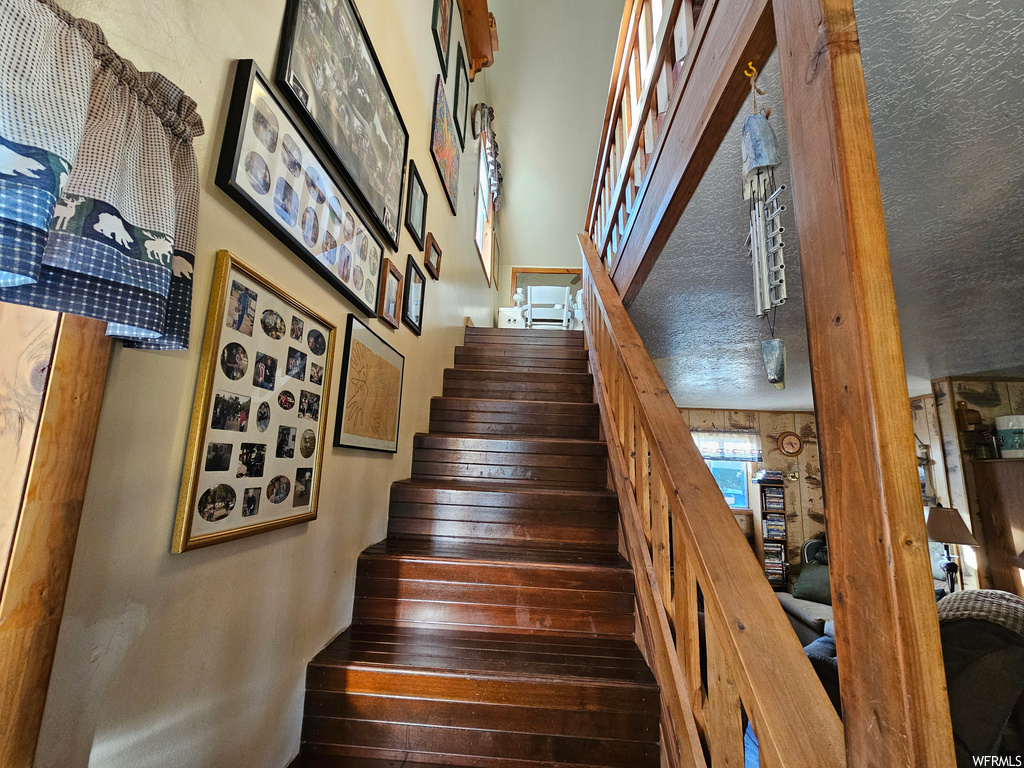 Stairs featuring dark hardwood floors