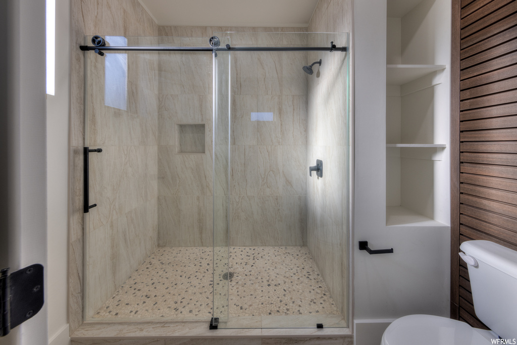 Bathroom with a shower with door and toilet