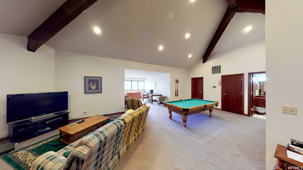 Recreation room with light colored carpet, pool table, vaulted ceiling high, and beamed ceiling
