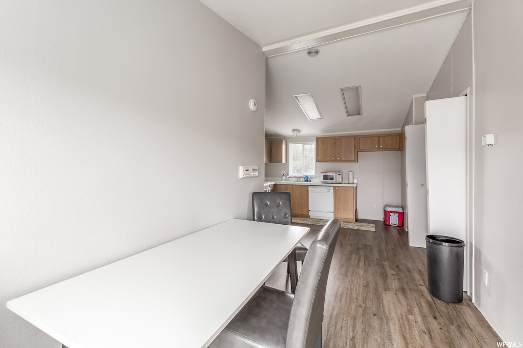 Dining area with wood-type flooring and lofted ceiling