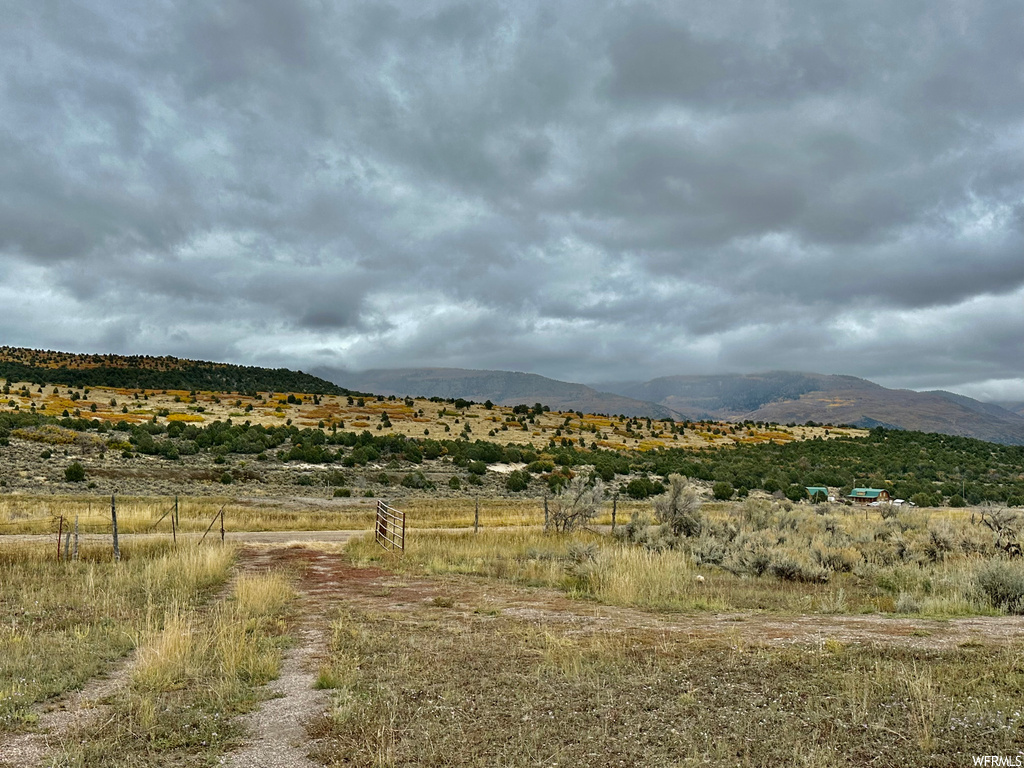 Property view of mountains with a rural view