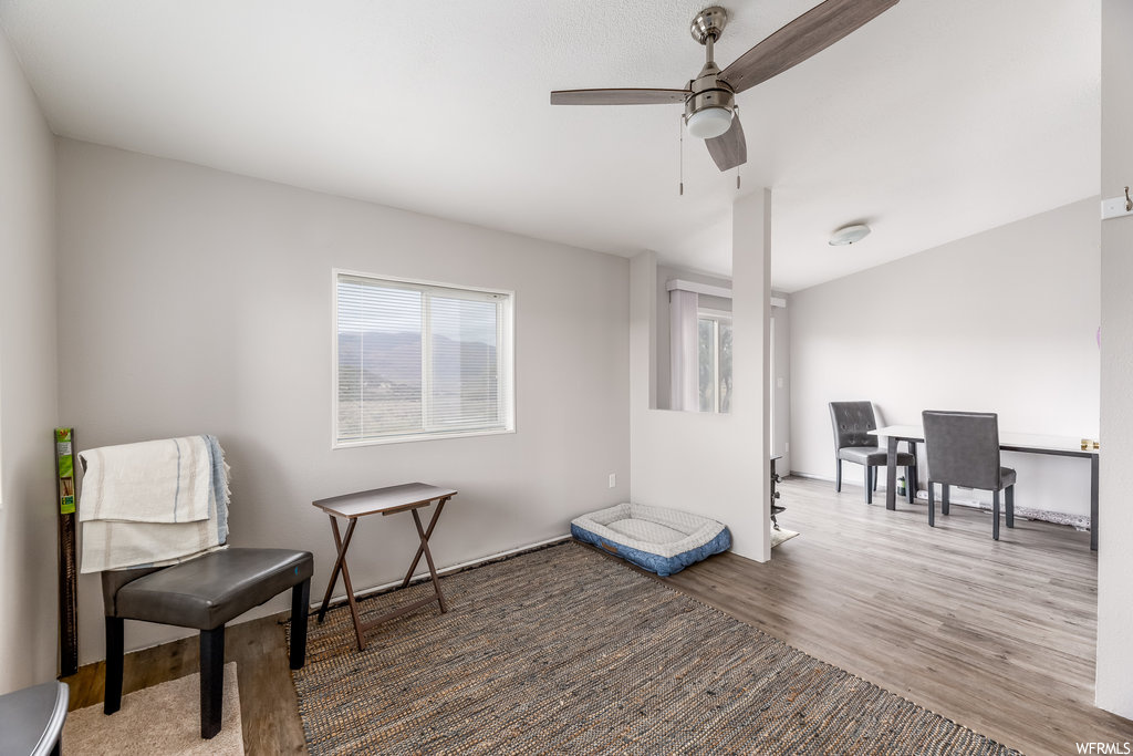 Sitting room with hardwood flooring and ceiling fan