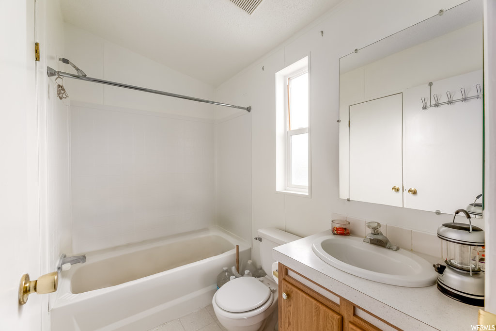 Full bathroom with shower / bath combination, toilet, vanity with extensive cabinet space, and plenty of natural light