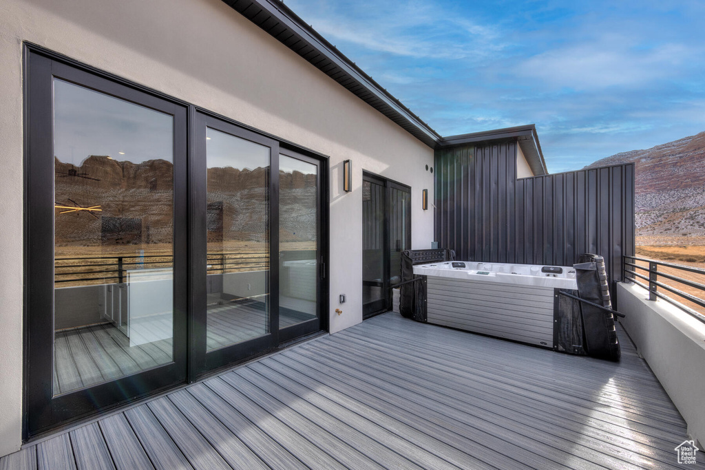 Wooden deck featuring an outdoor hot tub