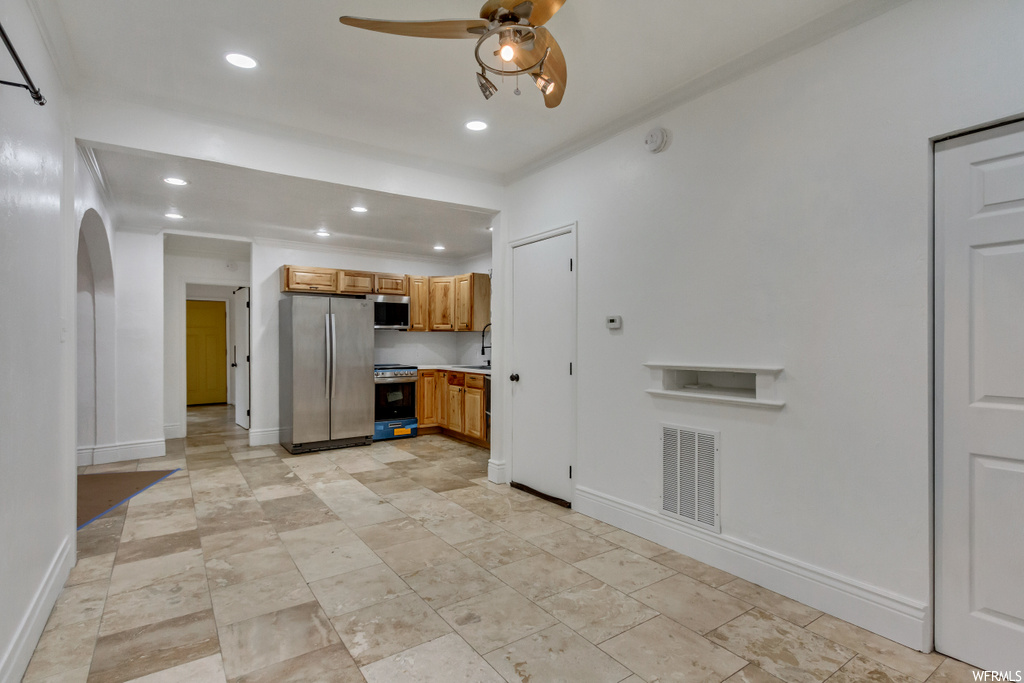 Kitchen featuring ceiling fan, light tile floors, and appliances with stainless steel finishes