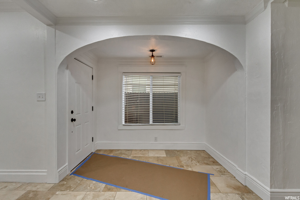 Tiled entryway with crown molding