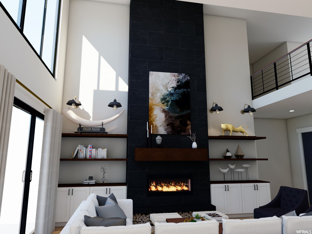 Living room with a high ceiling and a tiled fireplace