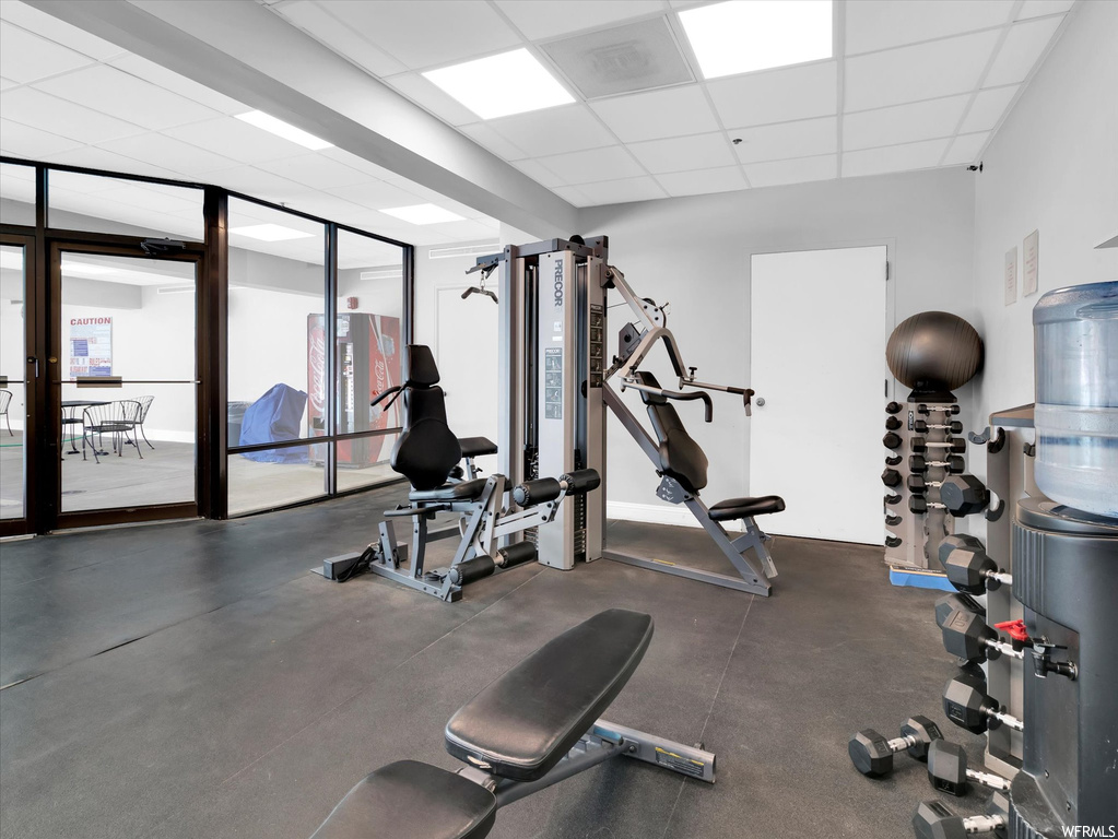 Workout area with expansive windows and a drop ceiling