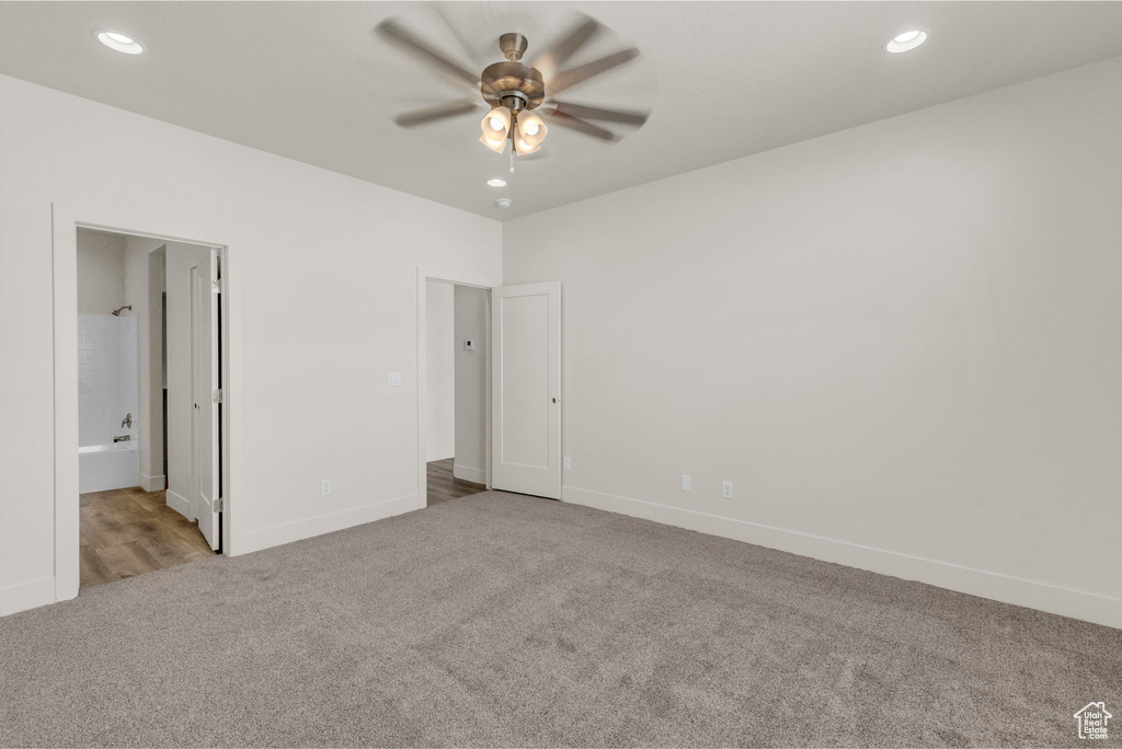 Unfurnished room with ceiling fan and light colored carpet