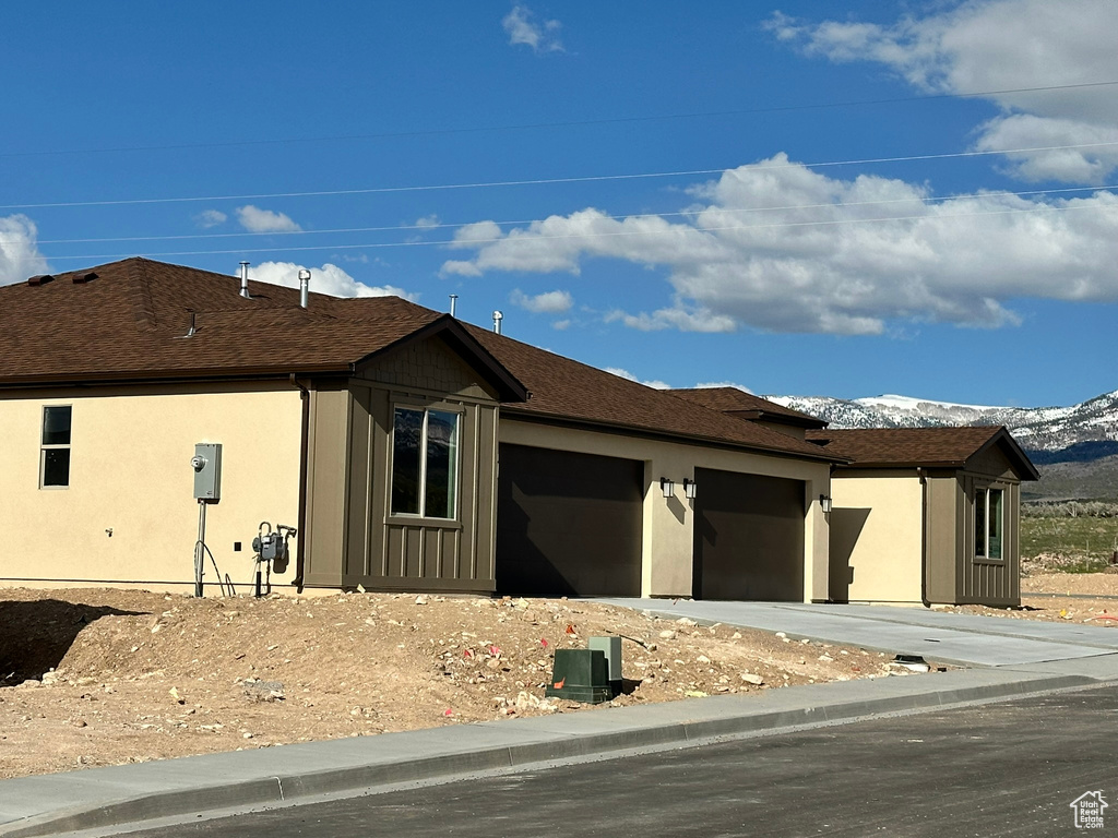 View of front of home featuring a mountain view and a garage