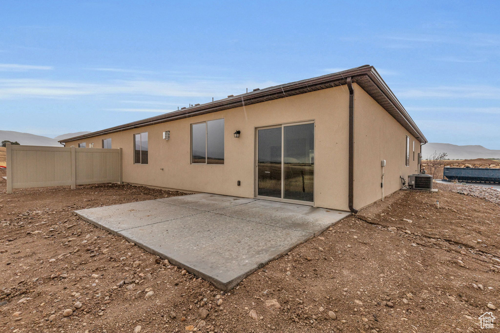 Back of house with a patio and central air condition unit