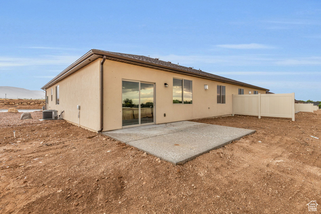 Back of property featuring central AC and a patio area