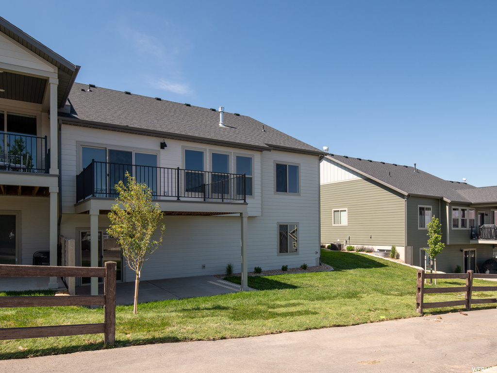 Exterior space featuring a balcony and a yard