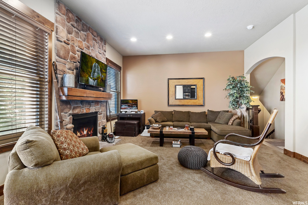 Living room with a fireplace and carpet