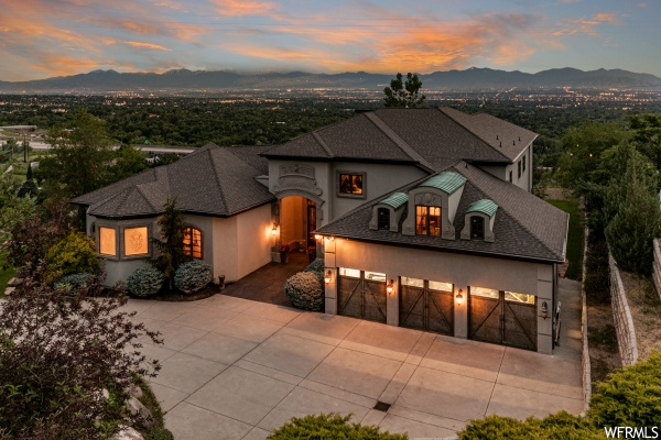 View of front of property featuring a garage and a mountain view