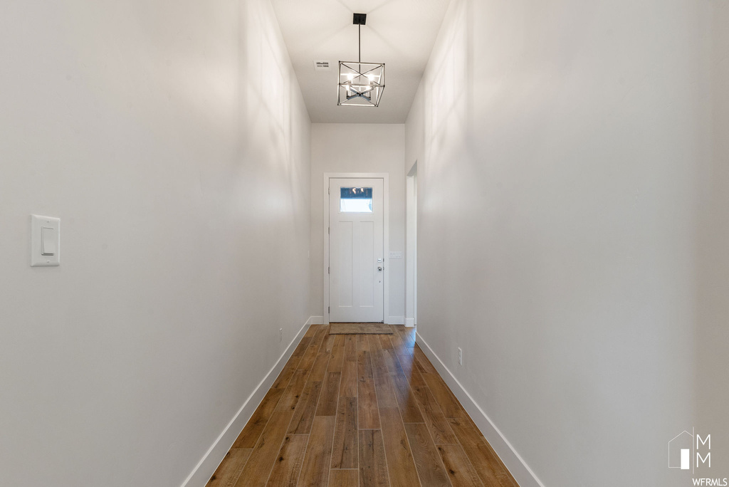 Entryway featuring a notable chandelier and dark hardwood / wood-style floors