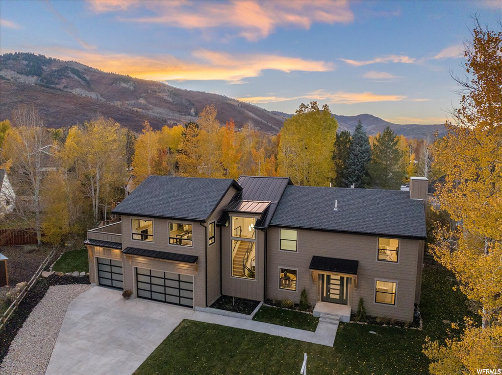 Contemporary home featuring a mountain view and a garage