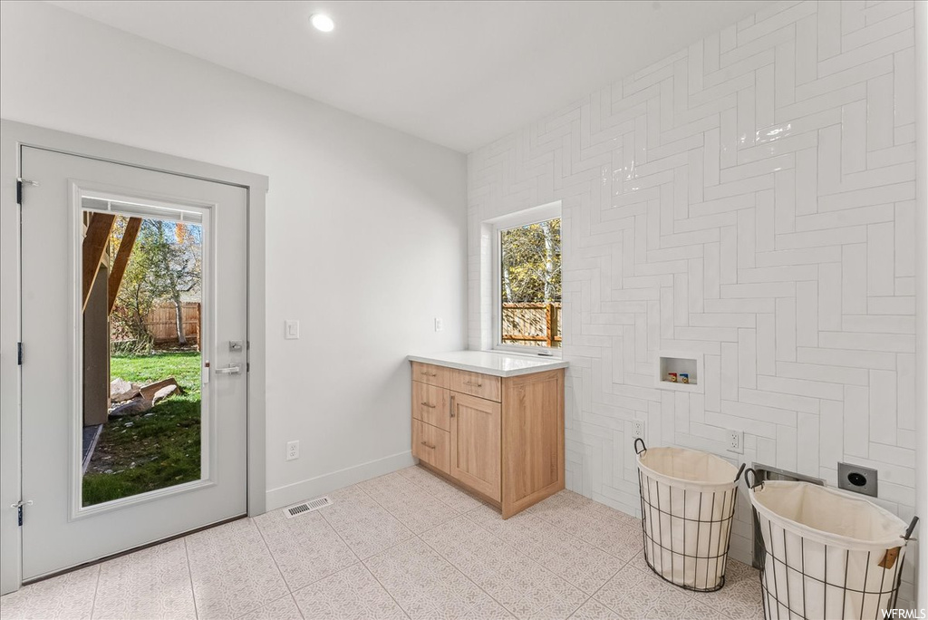 Bathroom featuring plenty of natural light, tile flooring, and vanity