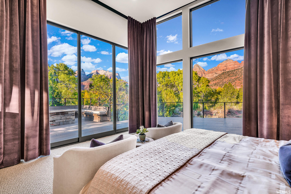 Bedroom with a mountain view and access to outside