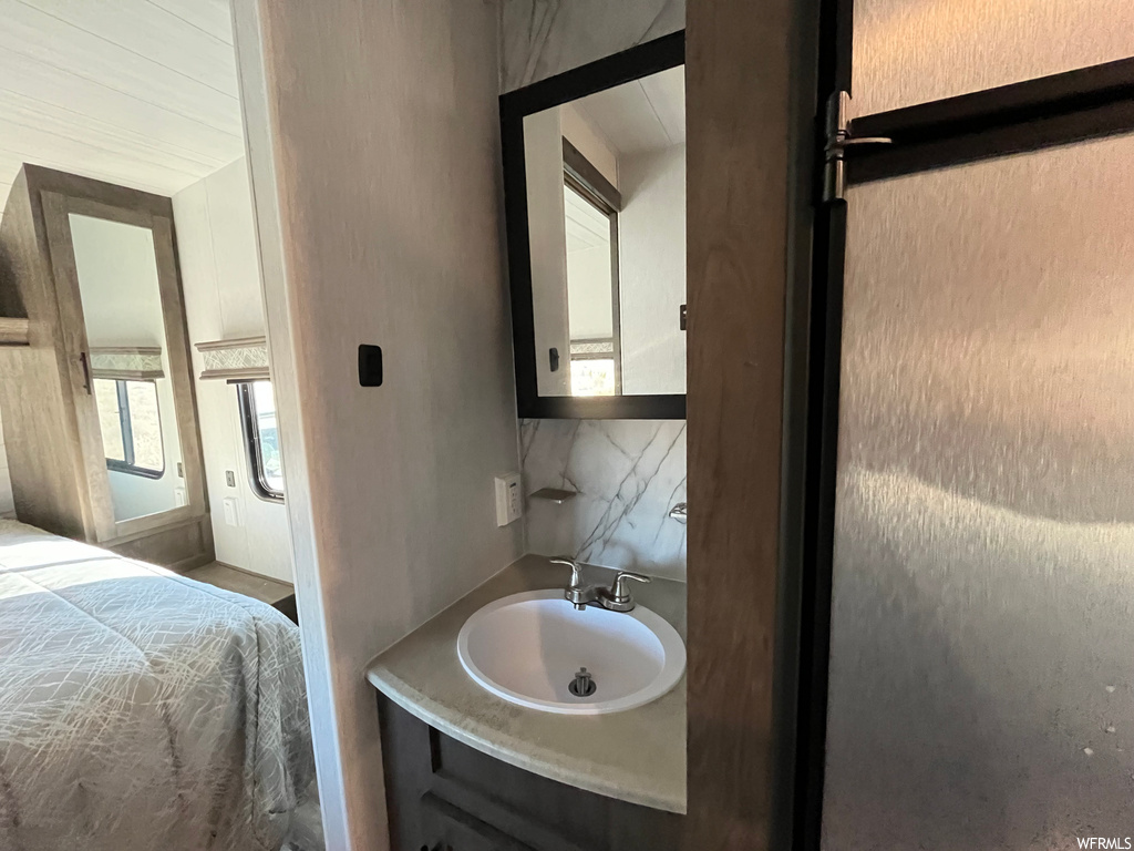 Bathroom with backsplash and large vanity